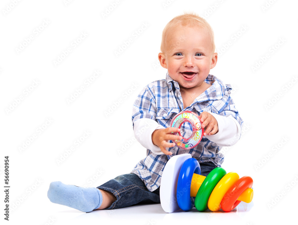Cute little boy playing with pyramid toy over white background Cute little boy playing with pyramid toy over white background