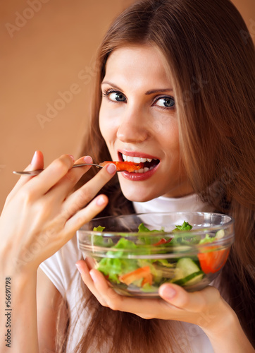 happy healthy woman eating salad, close up