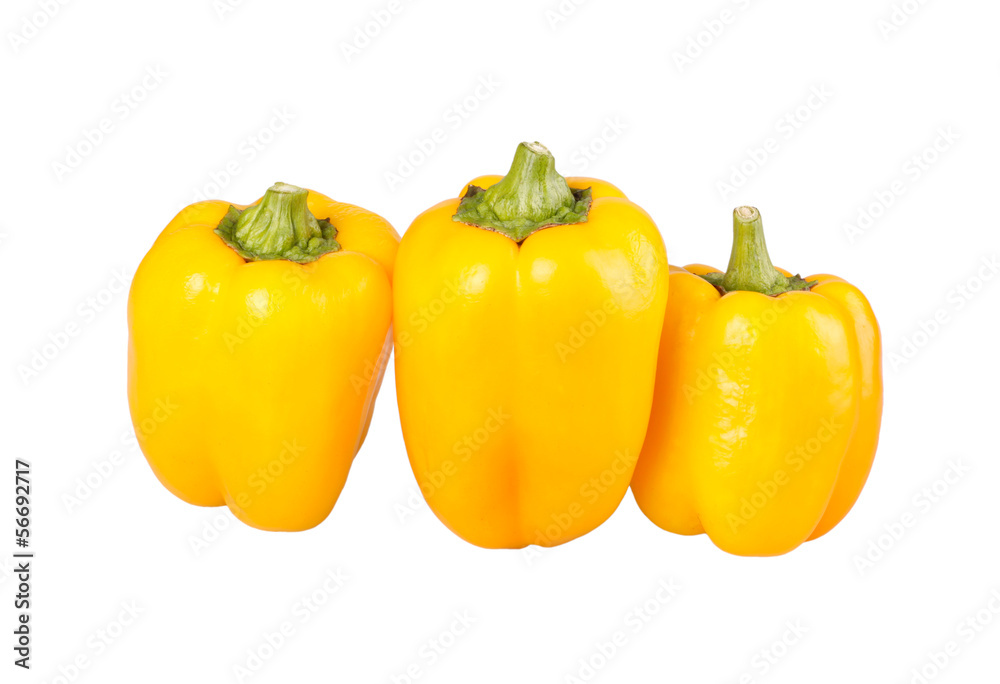 Three yellow bell peppers isolated against white Three yellow bell peppers isolated against white