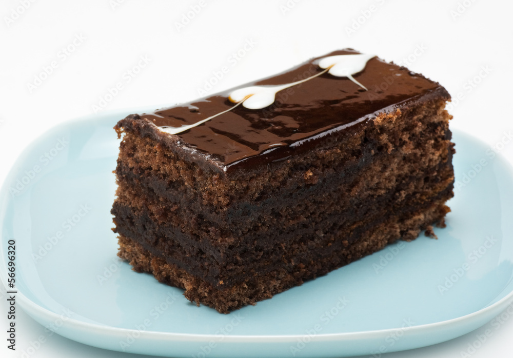 A piece of chocolate cake on a blue plate A piece of chocolate cake on a blue plate