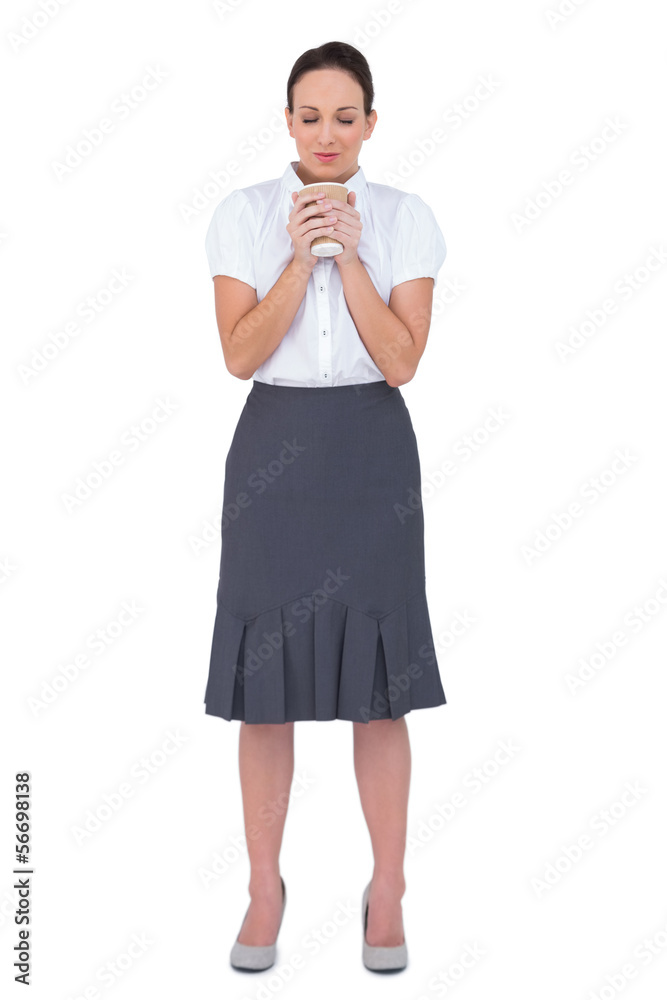 Relaxed businesswoman smelling coffee Relaxed businesswoman smelling coffee
