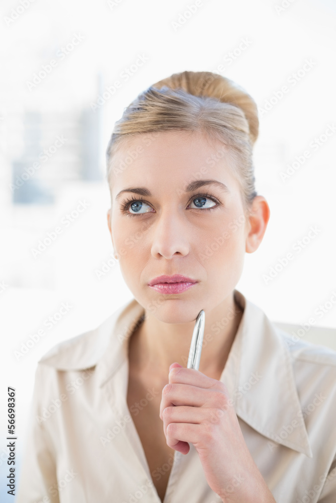 Wondering young blonde businesswoman looking away Wondering young blonde businesswoman looking away