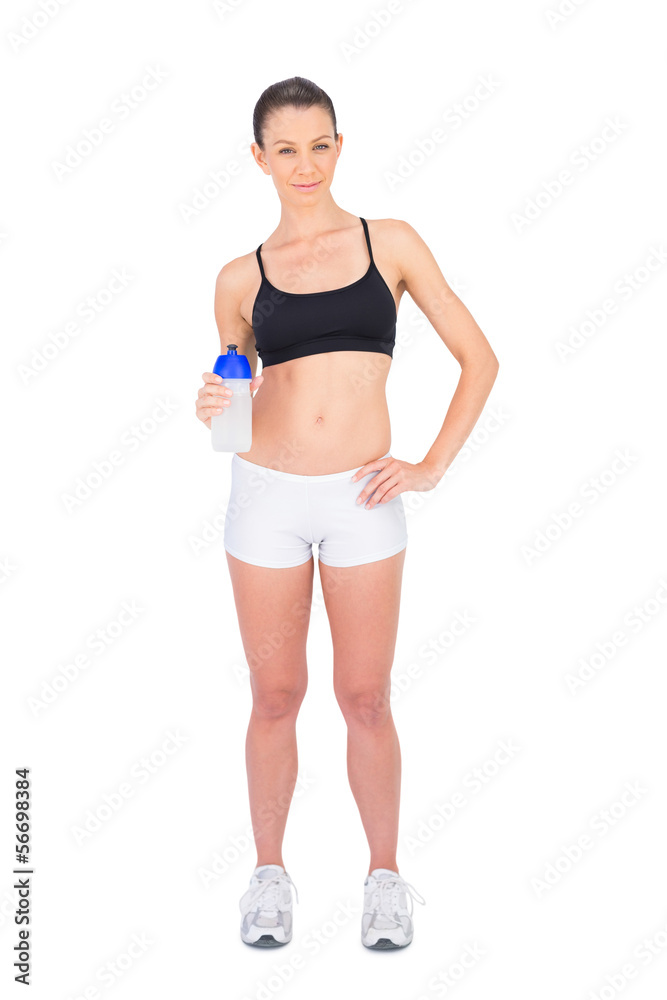 Peaceful woman in sportswear holding flask Peaceful woman in sportswear holding flask