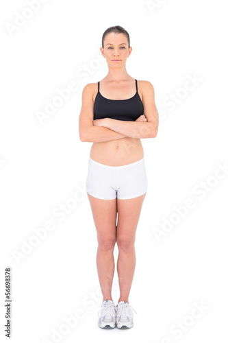 Serious woman in sportswear crossing arms