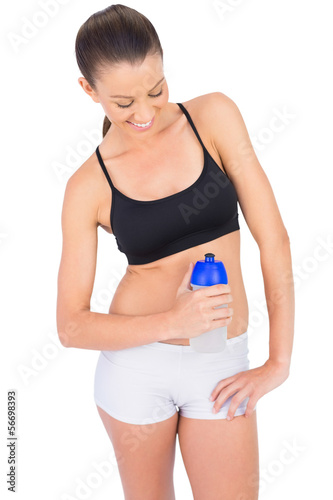 Happy toned woman in sportswear holding flask © lightwavemedia