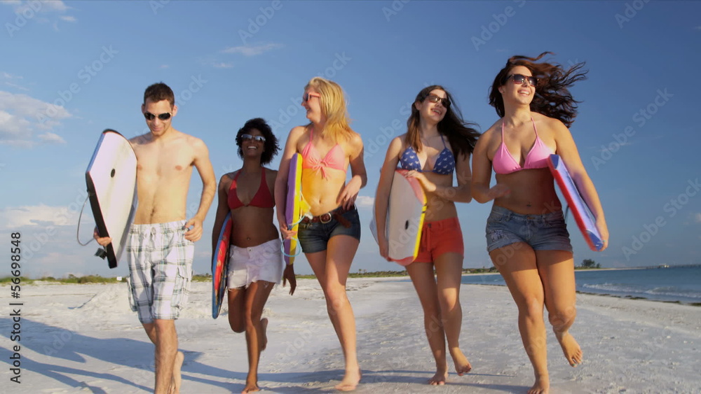 Young College Students Body Boards Enjoying Weekend Break Young College Students Body Boards Enjoying Weekend Break