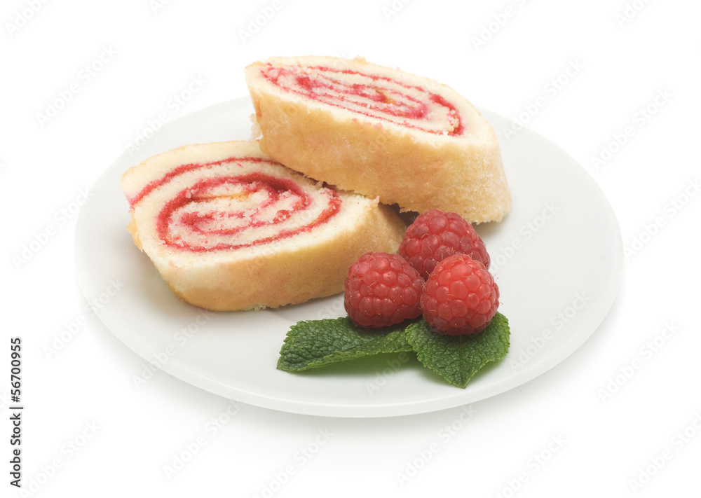 Sweet roll cake with raspberry jam and berries, isolated on a wh Sweet roll cake with raspberry jam and berries, isolated on a wh