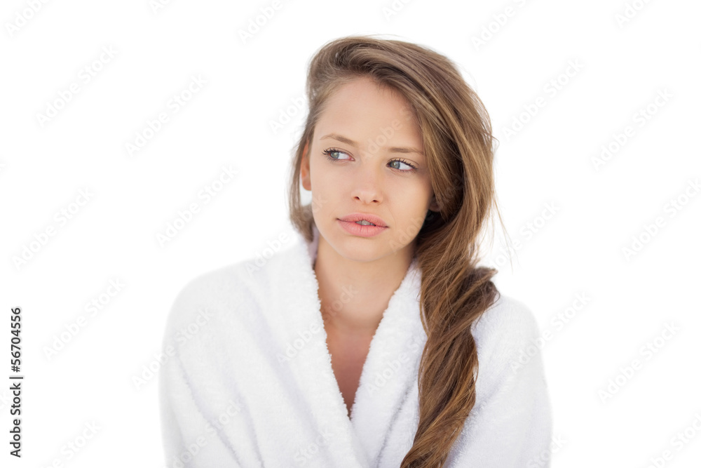 Thoughtful brunette in bathrobe looking away Thoughtful brunette in bathrobe looking away