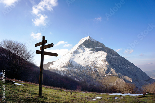 signpost near snowy mountain