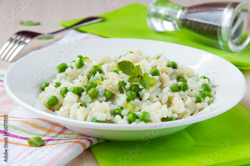 Italian risotto with rice, green peas, mint and cheese