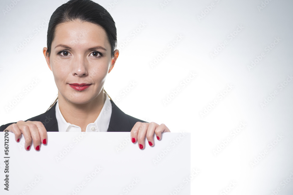 Smiling businesswoman holding a blank board Smiling businesswoman holding a blank board