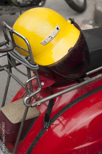 Yellow helmet on red scooter