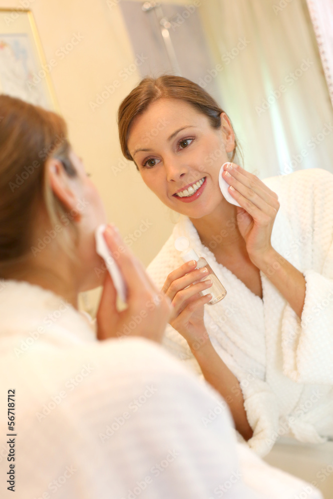 Beautiful woman in bathroom taking makeup off Beautiful woman in bathroom taking makeup off