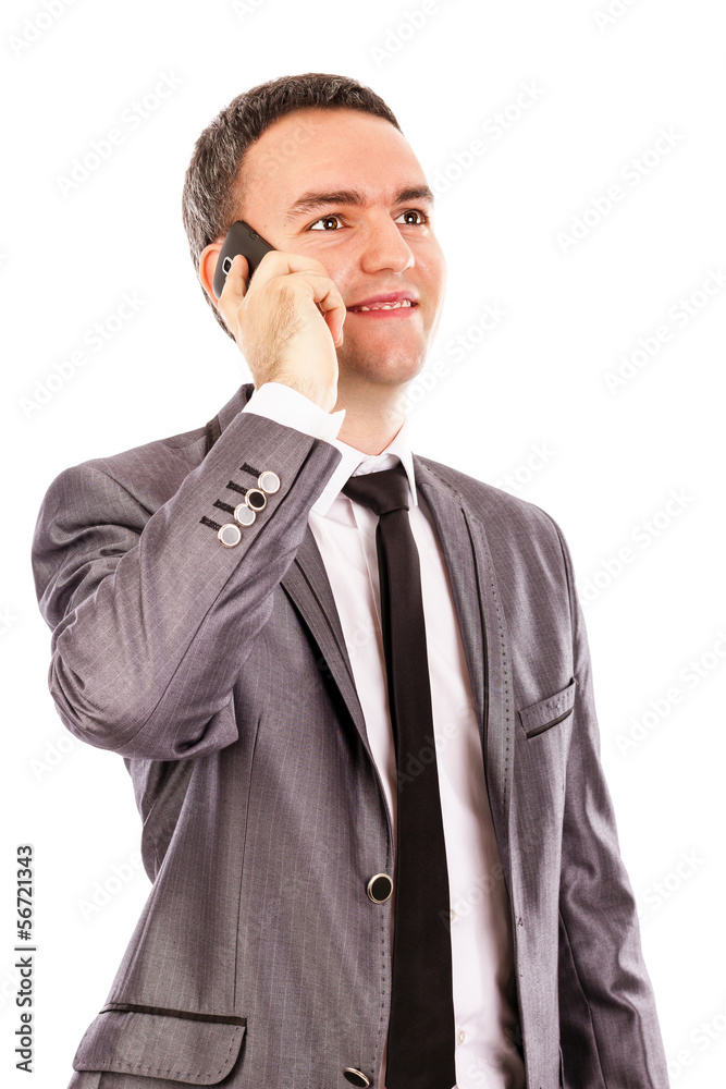Happy young businessman talking at the phone and looking up Happy young businessman talking at the phone and looking up