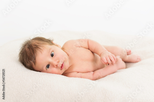 Cute baby with soft skin in the bed