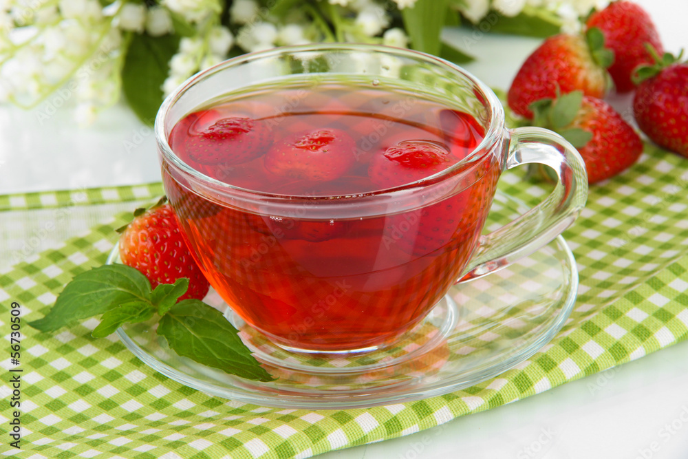 Delicious strawberry tea on table close-up Delicious strawberry tea on table close-up