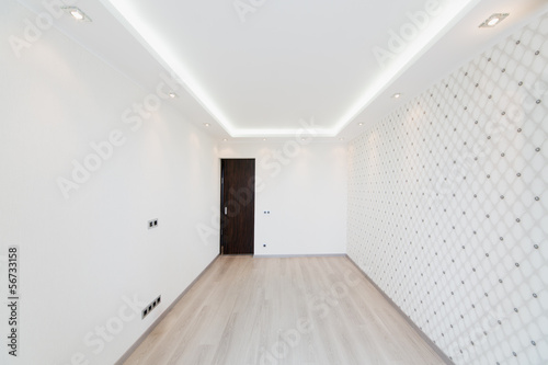 Modern empty room with a geometric pattern on the wall photo