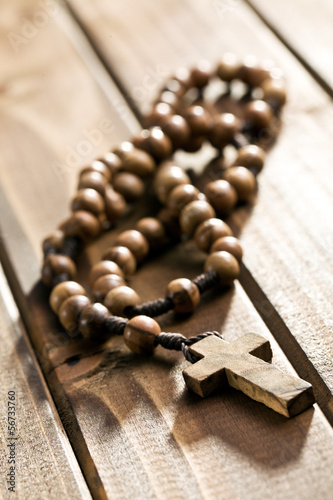 rosary beads on wooden background
