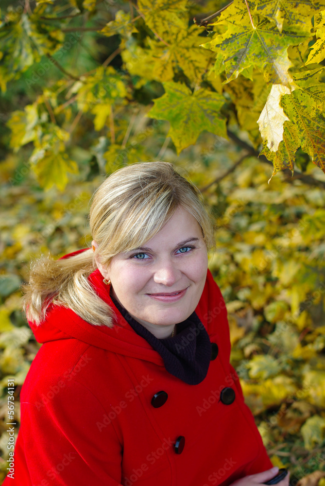 Beautiful young woman in autumn forest in red clothes. Beautiful young woman in autumn forest in red clothes.