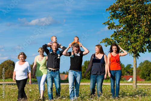 Family and multi-generation - fun on meadow in summer