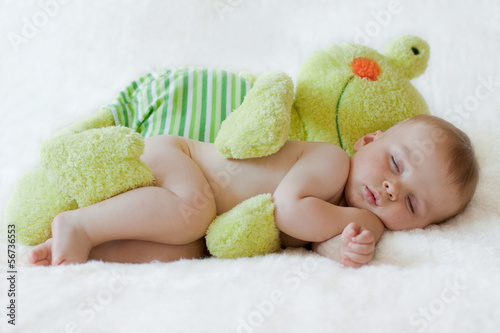Baby boy, sleeping with a frog toy © Tomsickova