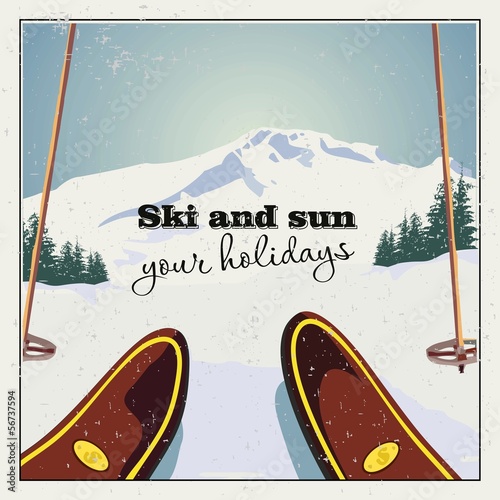 Skier is preparing to descend against the  mountain landscape.