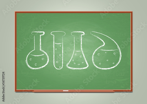 School blackboard with chemical test-tube symbols