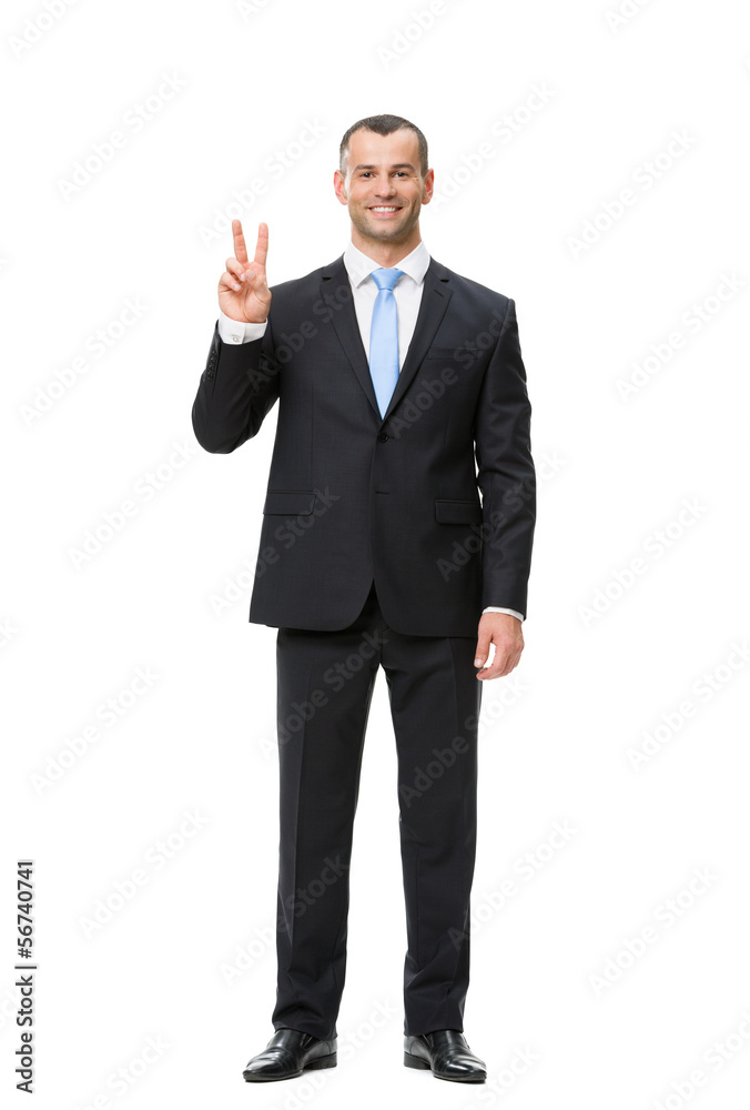 Full-length portrait of businessman peace gesturing