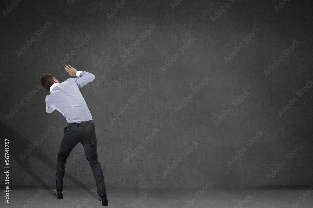 Back view of shocked and scared young business man. Holds hands Back view of shocked and scared young business man. Holds hands