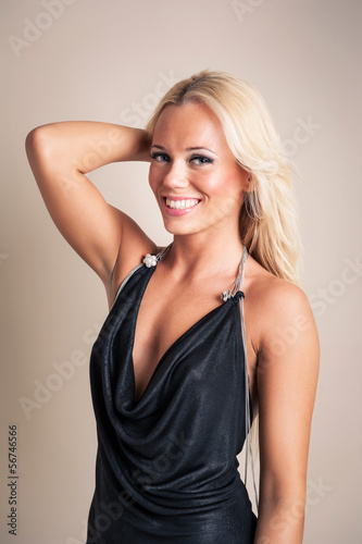 Blonde woman portrait with elegant black dress.