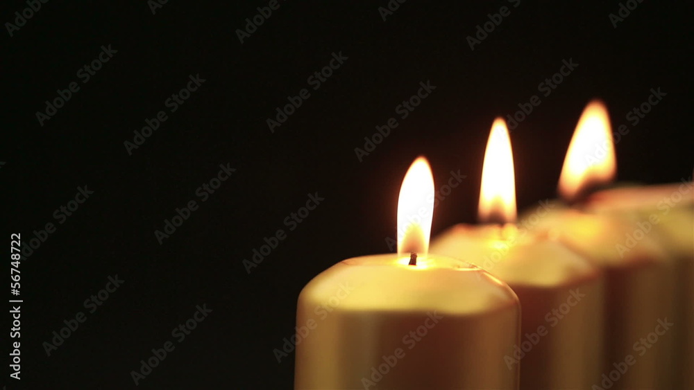 Hand lighting christmas candles and blowing them out