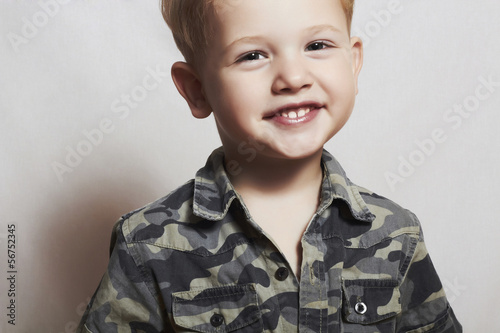 smiling child. funny little boy. 4 eyers old. military shirt