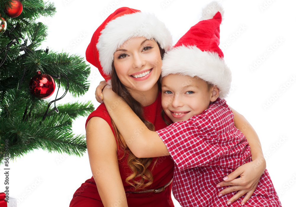 happy mother and child boy in santa helper hats happy mother and child boy in santa helper hats