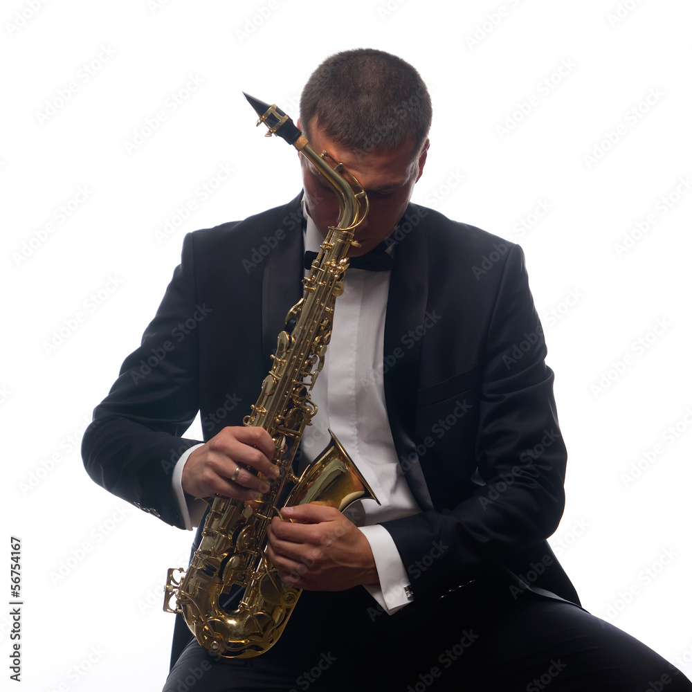 Naklejka premium Isolated portrait of sitting saxophonist in tuxedo