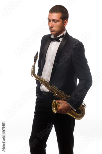 Isolated portrait of young saxophonist in suit with tie