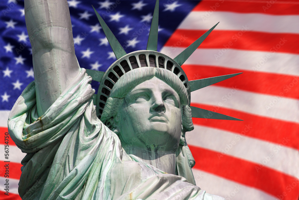 Fototapeta premium Statue of Liberty on Island in New York with flag of the USA