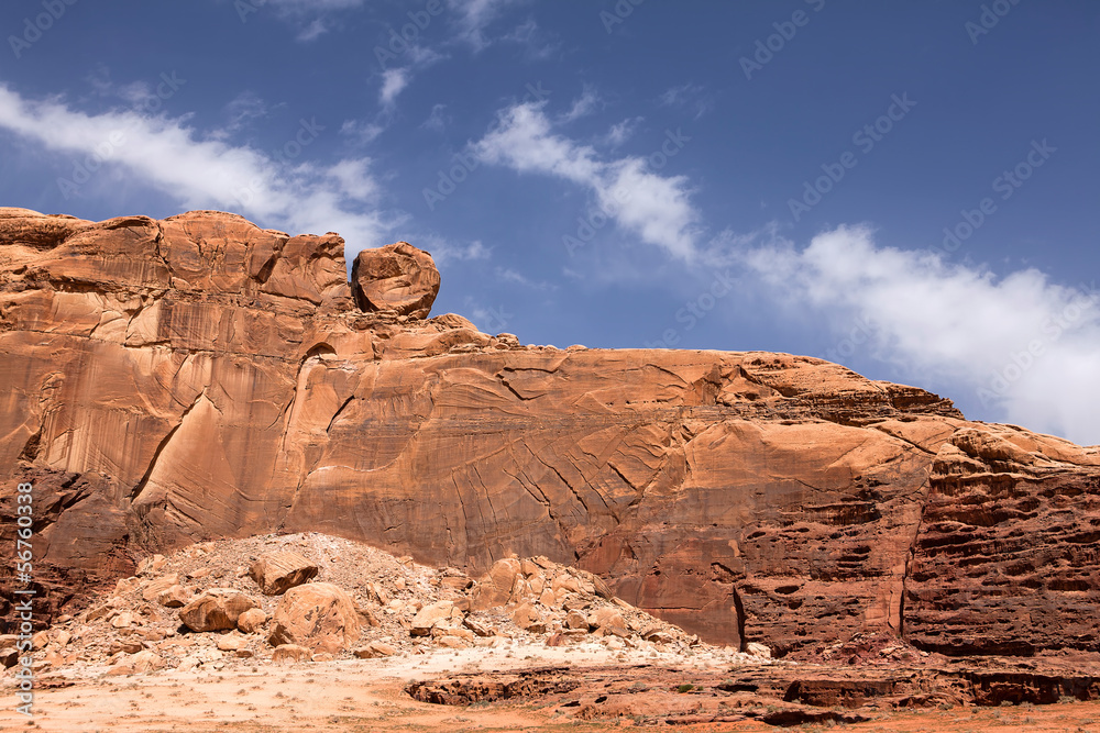 A Wadi Rum mountain with unusual rolling stone on it A Wadi Rum mountain with unusual rolling stone on it