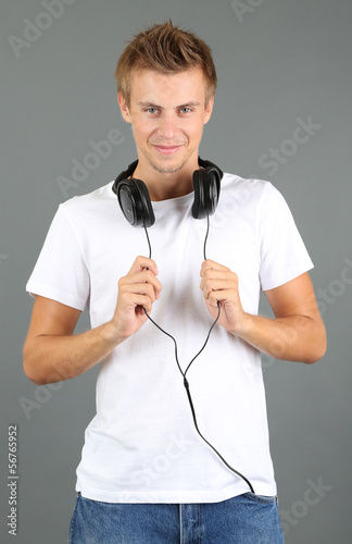 Handsome young man listenin...