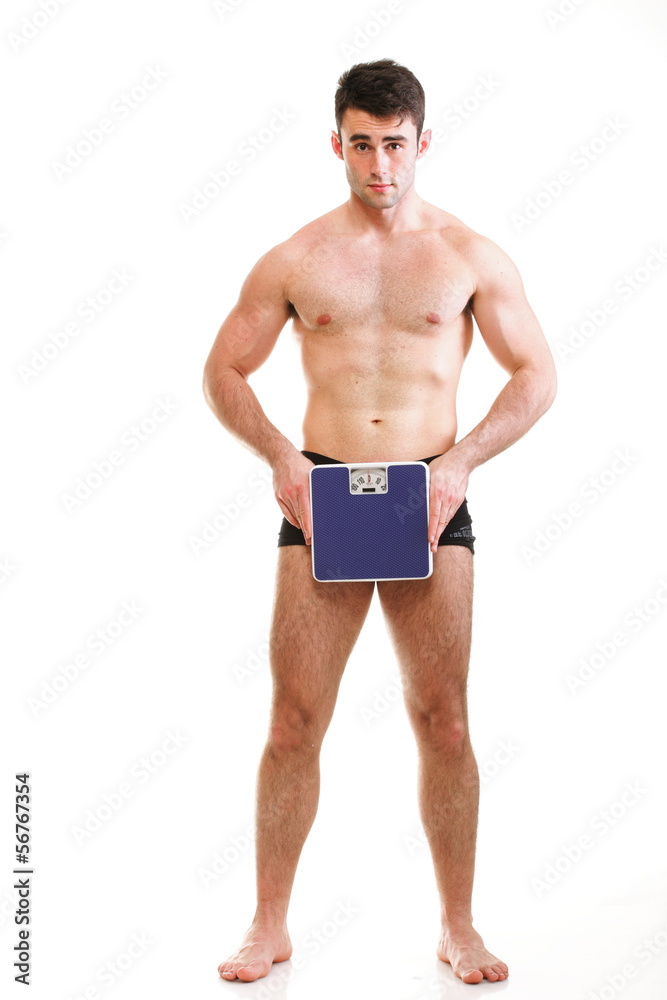 Healthy young man with a weight scale Isolated Healthy young man with a weight scale Isolated