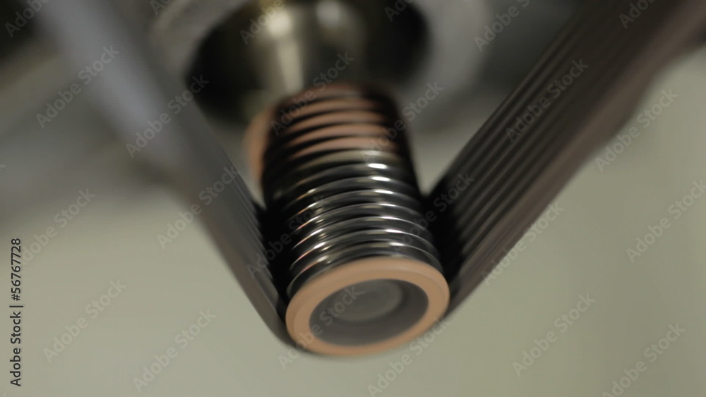 Belt drive. Metal shaft as it turns. Belt drive. Metal shaft as it turns.