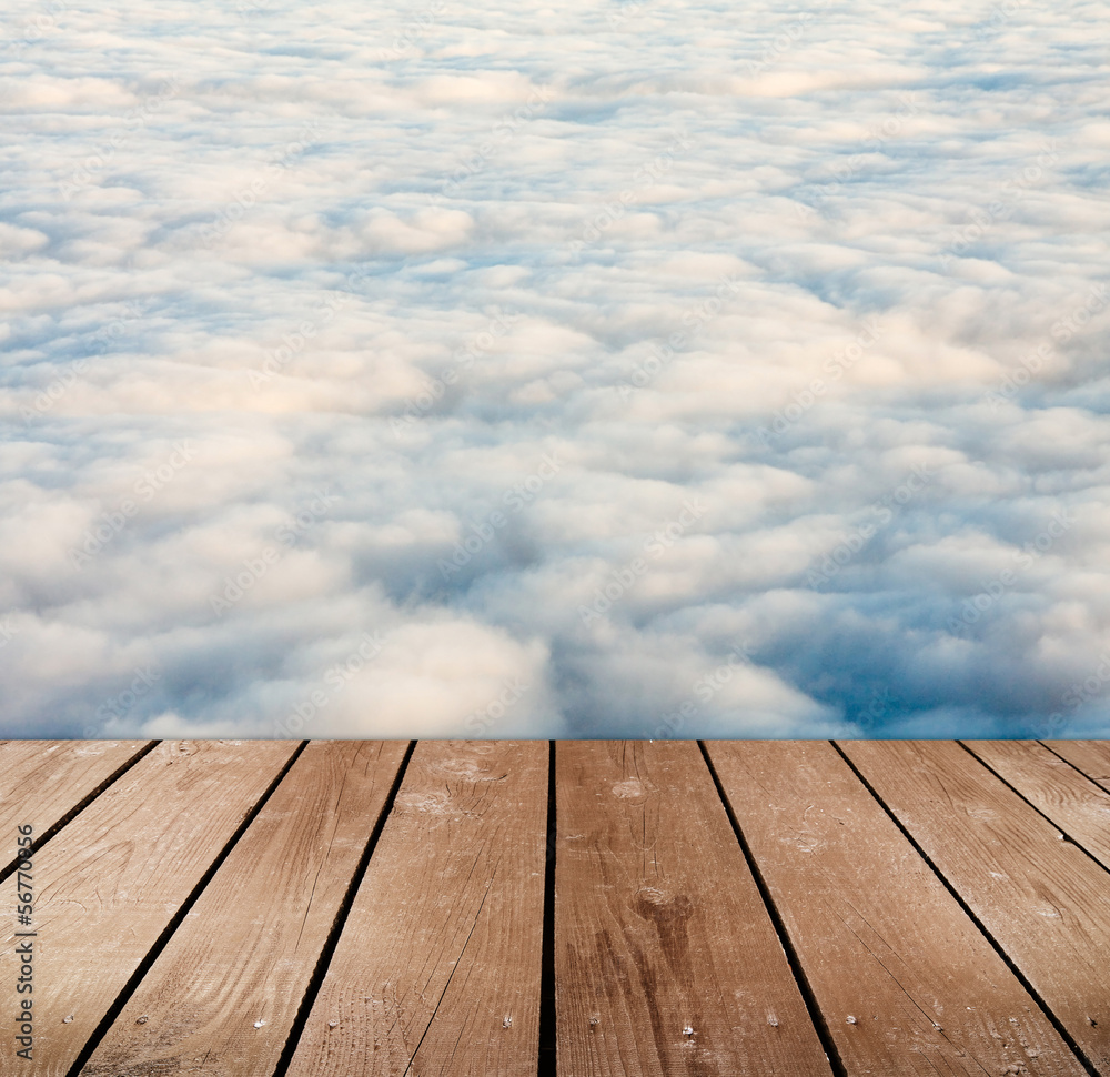 empty wooden deck table with clouds. 