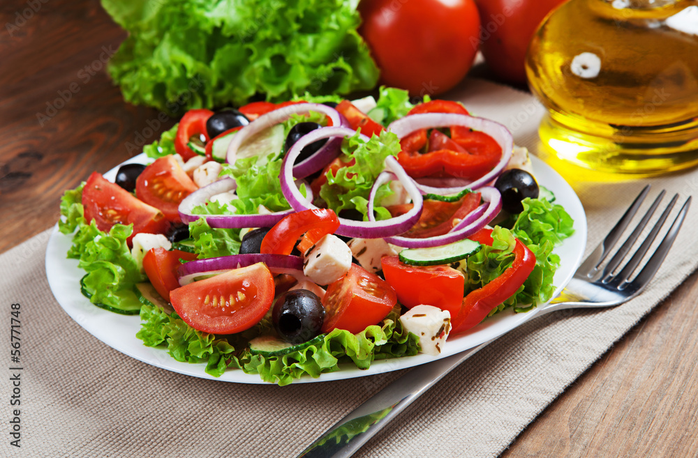 The Greek and Italian food - fresh vegetable salad on the table The Greek and Italian food - fresh vegetable salad on the table