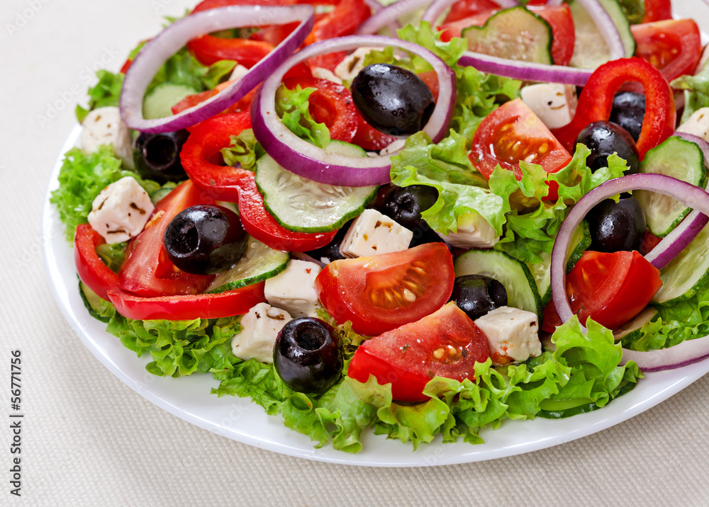 The Greek and Italian food - fresh vegetable salad on the table The Greek and Italian food - fresh vegetable salad on the table