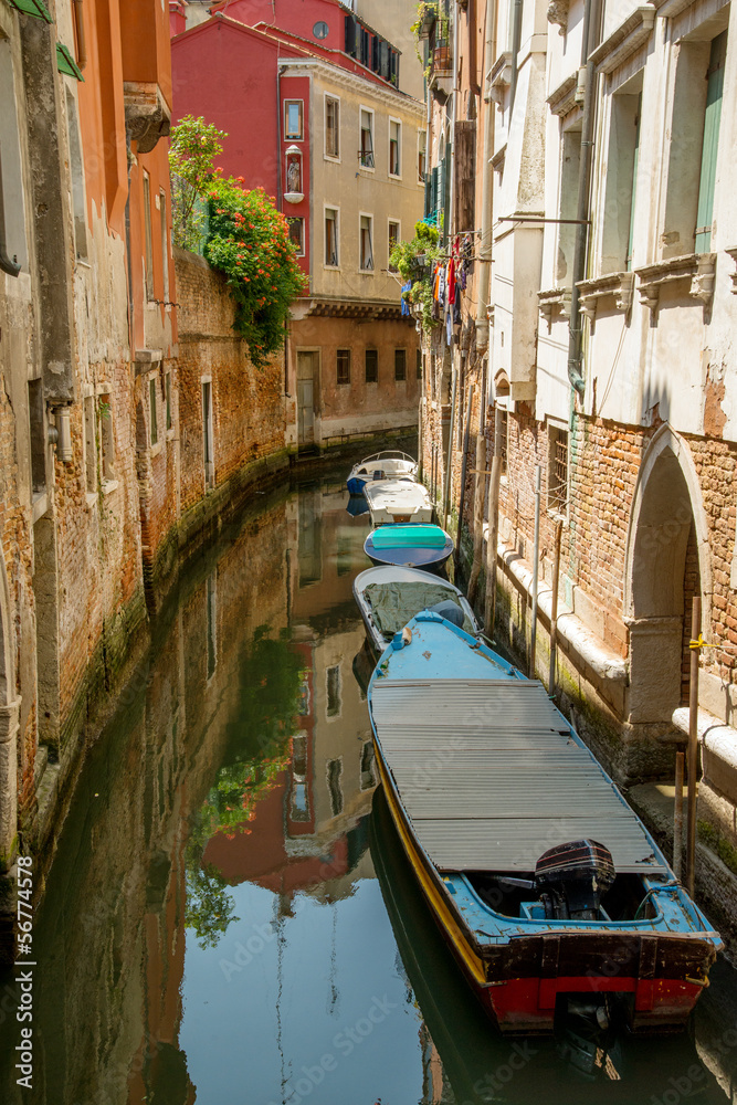 Colorful buildings and boats in Venice canal passage