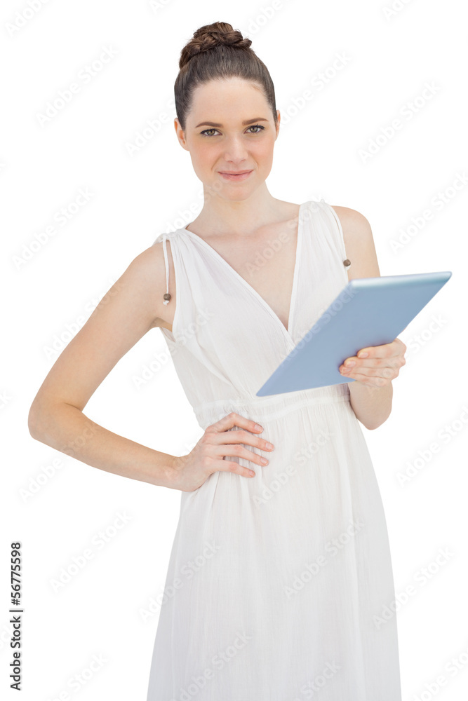 Young model in white dress holding tablet computer Young model in white dress holding tablet computer