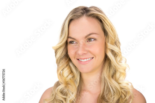 Cheerful curly haired blonde posing