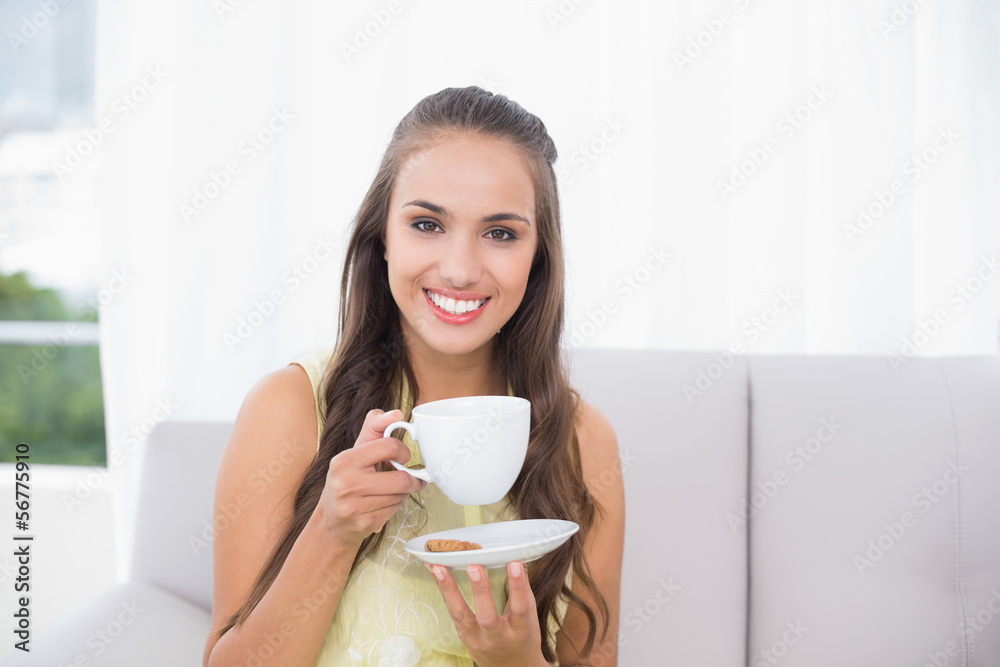 Smiling pretty brunette holding a cup Smiling pretty brunette holding a cup