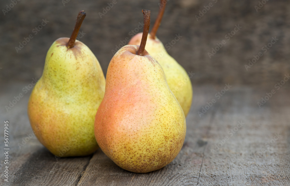 Fresh juicy pears in rustic wooden setting Fresh juicy pears in rustic wooden setting
