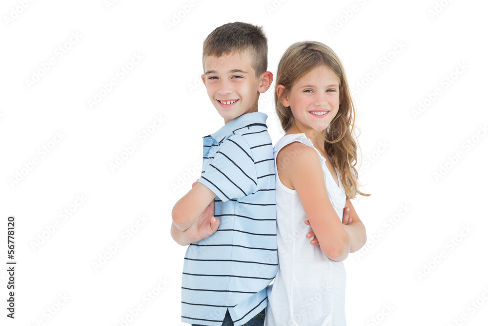Happy young brother and sister posing back to back Happy young brother and sister posing back to back
