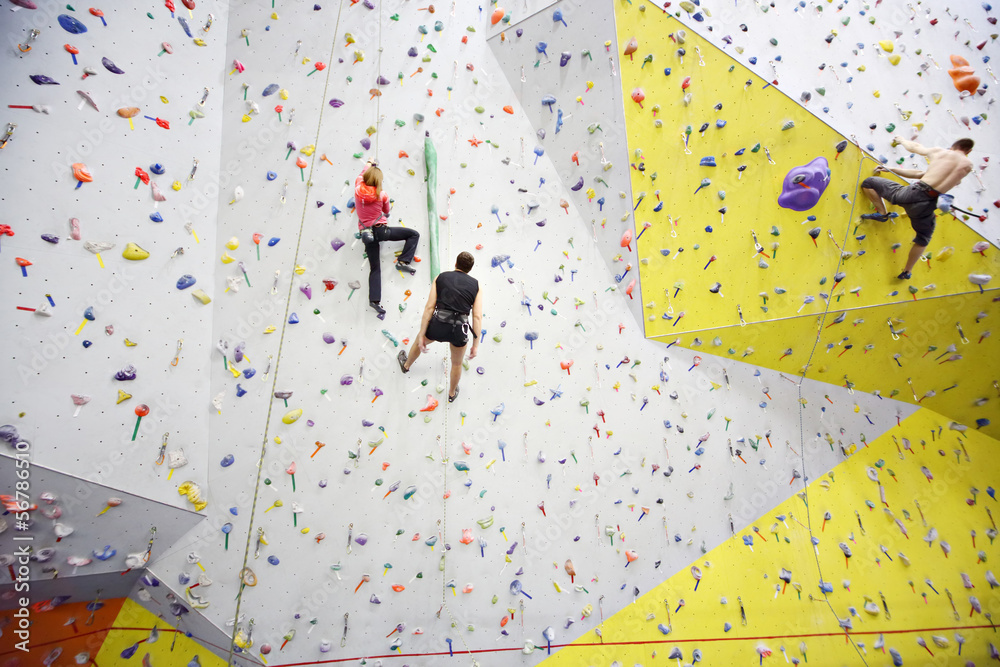 People involved in climbing in a climbing gym StockFoto Adobe Stock
